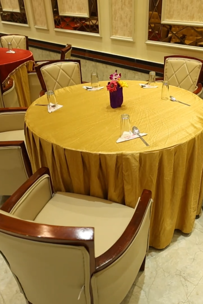 Chocolate pastries on a dark blue table with flower petals